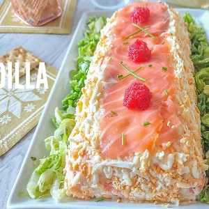 Ensaladilla de merluza y salmón presentada sobre lechuga