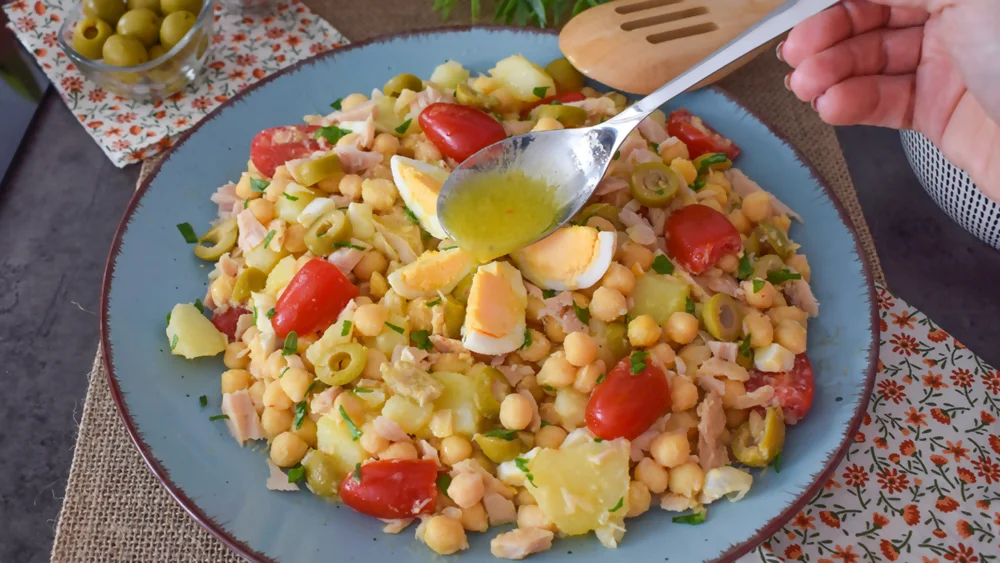 Aliñando ensalada de garbanzos con patatas y atún con vinagreta casera