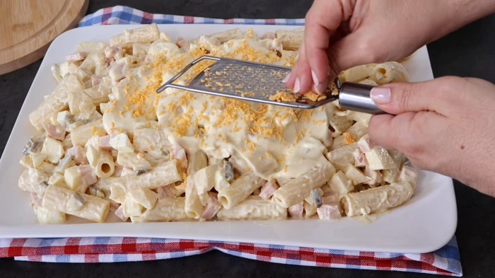 Huevo rallado sobre ensalada americana