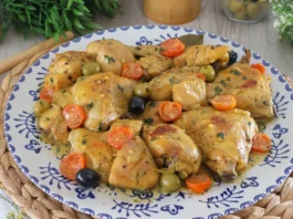 Pollo a la mediterránea servido en fuente con tomates cherry y aceitunas