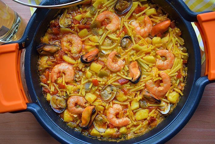 Fideos a la marinera con marisco servidos en cazuela