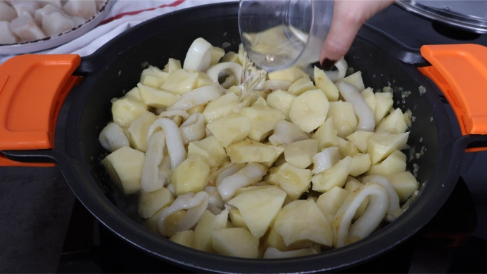 Añadir vino blanco al guiso de merluza y calamares  