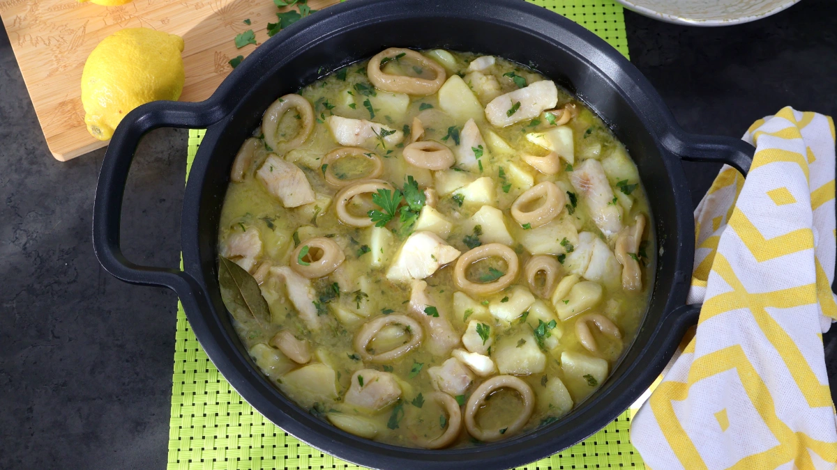 Cazuela de merluza y calamares con patatas en salsa verde vista cenital